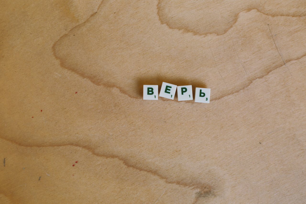 Scrabble tiles with Cyrillic letters spelling верь displayed on a wooden surface.